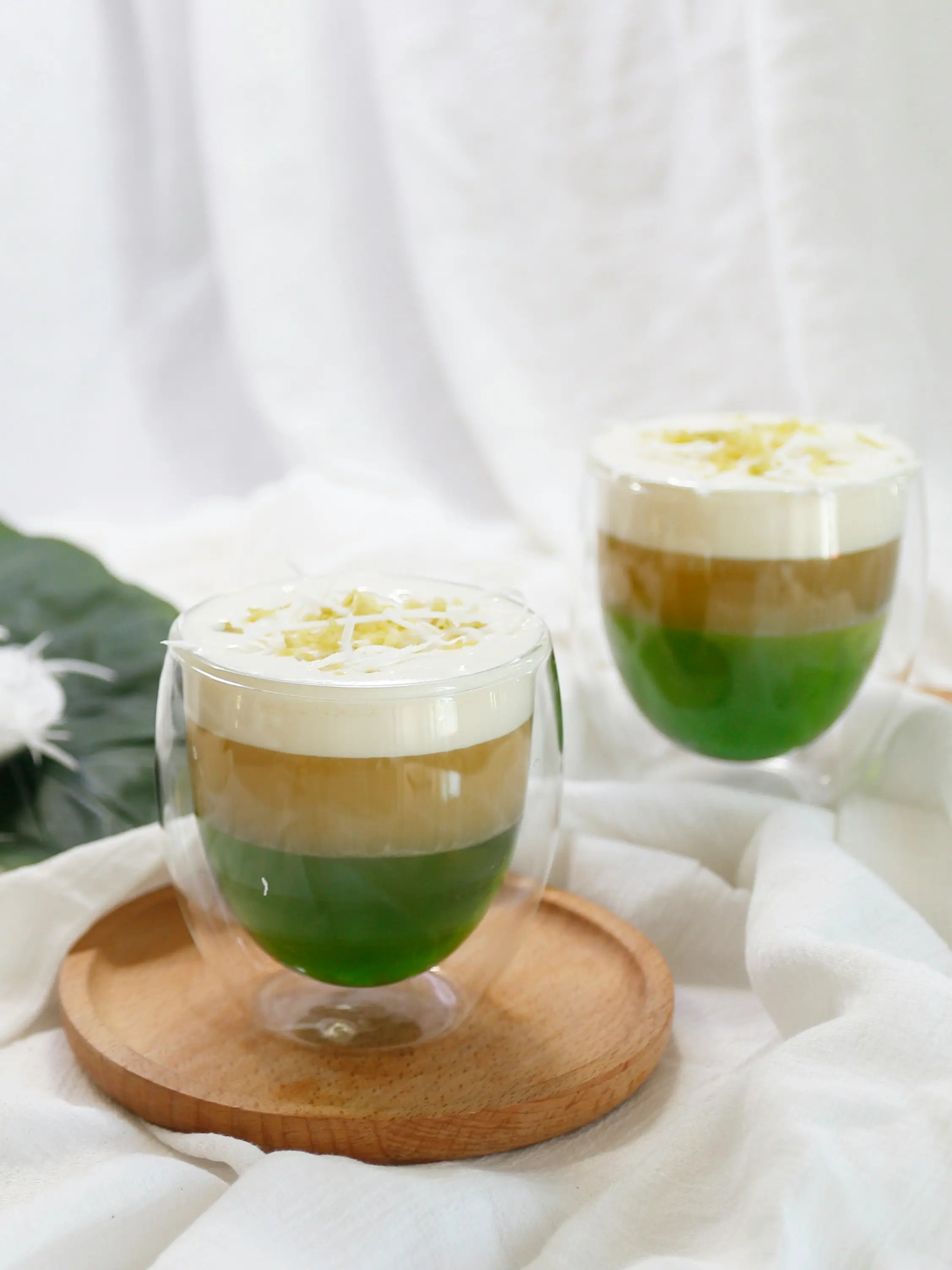 Layered pandan latte drinks with foam