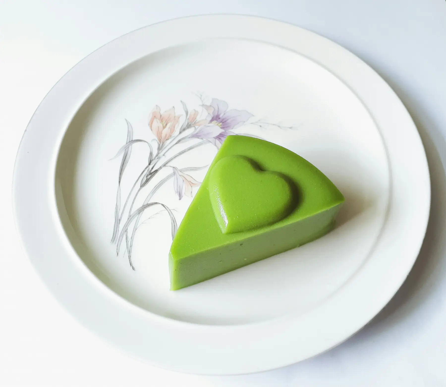 Elegant pandan cake slice on decorative porcelain plate